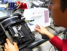 Vacuum repair technician servicing internal components on a workbench in Orlando, FL