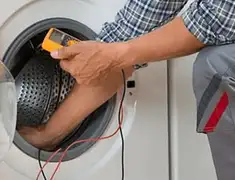 Washing machine repair technician testing a front-load washer with diagnostic tools in Orlando, FL